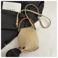 Detail of vintage canvas crossbody bag with bronze clasp and brown leather handle - Khaki