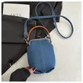 Detail of blue denim mini handbag with white stitching and round brown leather handle - Dark Blue
