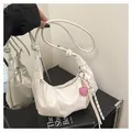 Detail of white pleated crescent bag with heart charm and decorative knotted strap - No Pendant / White