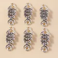 Macro view of six vintage silver alloy hollow fishbone charms for DIY jewelry making - Antique Silver