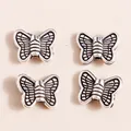Detailed view of four vintage silver butterfly charms for DIY jewelry making - Butterfly Design / 50 Pieces / Antique Silver