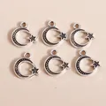 Macro shot of vintage silver moon and star alloy pendants with detailed textured finish - Antique Silver