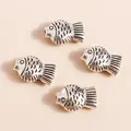 Detail of vintage silver fish charms for DIY jewelry with textured scales and fins - Antique Silver