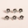 Macro shot of 6 antique silver flower pendants with five-petal texture for DIY jewelry - Antique Silver