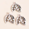 Macro detail of three vintage silver-plated leaf pendants for DIY jewelry making - Antique Silver