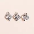 Detailed view of silver alloy strawberry charms for DIY jewelry making with textured seeds - Antique Silver