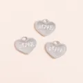 Detailed view of silver heart charms with LOVE engraving and beaded edge for DIY jewelry - Silver