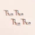 Macro shot of 4 vintage silver alloy high heel charms with detailed openwork for DIY jewelry - Silver