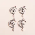 Macro detail of retro silver moon and fairy pendants for DIY jewelry making accessories - Silver