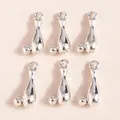 Detailed view of silver bowling pin pendants with top rings for DIY jewelry making - Silver