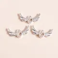 Close-up of three silver hollow heart wing pendants for DIY jewelry making accessories - Silver