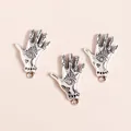 Macro shot of silver alloy Hamsa hand pendants with eye pattern and crystal inlay - Antique Silver