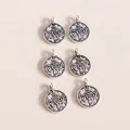 Close-up of vintage silver alloy coin charms with embossed numismatic details for DIY jewelry - Antique Silver