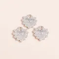 Macro view of silver plated alloy heart charms with LOVE engraving and lace edge - Silver