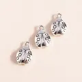 Close-up of vintage silver ladybug alloy pendants with detailed spots for DIY jewelry making - Antique Silver