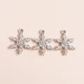 Detail showing three silver snowflake charms with intricate textures for DIY jewelry - Silver