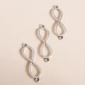 Close-up of three infinity-shaped silver alloy pendants with double loops for DIY jewelry - Silver