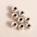 Detailed macro view of 8 pieces of silver plated alloy round beads with hammered texture - Round Beads / 100pcs Pack / Silver
