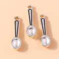 Macro shot of vintage silver-plated alloy mini spoon charms for DIY jewelry making - Spoon Style / Silver