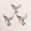 Detailed view of vintage silver hummingbird jewelry connectors with intricate feather textures - Antique Silver