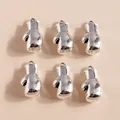 Macro detail of six silver boxing glove pendants arranged in a neat grid on beige - Silver