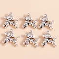 Detailed view of six antique silver balloon dog pendants for DIY jewelry crafting - Silver