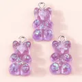 Close-up of three purple resin gummy bear charms with colorful glitter and silver loops - Purple