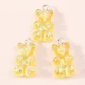 Detailed view of yellow resin gummy bear charms with colorful glitter for DIY jewelry making - Yellow