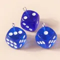 Macro shot of three translucent blue resin dice pendants with silver metal loops - Sapphire Blue