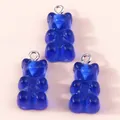 Macro detail of three dark blue resin gummy bear pendants with silver metal loops - Sapphire Blue