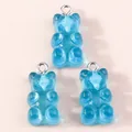 Detail view of three translucent blue resin bear pendants with silver metal loops - Lake Blue