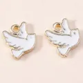 Detailed macro view of two white enamel peace dove charms with golden metal edges - White