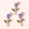 Detail of three blue enamel rose flower charms with gold alloy edges for DIY jewelry - Blue