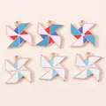 Close-up of colorful enamel windmill pendants with gold alloy edges for DIY jewelry crafts - Multicolor