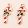 Detailed view of red and white striped enamel candy cane charms with holly leaves decoration - Red