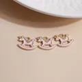 Three pink enamel unicorn rocking horse charms with golden alloy plating and loops - Pink