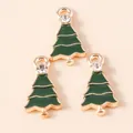 Close-up of green enamel Christmas tree pendants with gold plating and rhinestone details - Green