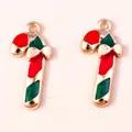 Close-up of red and green enamel Christmas candy cane charms with gold bow accents - Red