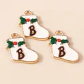 Close-up of white enamel Christmas sock pendants with green holly and letter B design - White