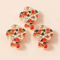 Detailed close-up of three Christmas candy cane charms with festive red and green enamel - Red