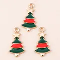 Macro detail of three enamel Christmas tree pendants with gold stars for DIY jewelry - Green