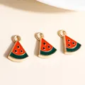 Detail of three alloy watermelon pendants with red enamel and gold-plated edges for DIY - Red