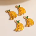 Close-up of four alloy enamel banana pendants for DIY jewelry making and crafts - Yellow
