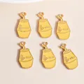 Macro shot of 6 yellow banana milk bottle charms made of alloy with gold enamel detailing - Banana Milk Bottle / Yellow