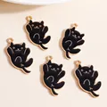 Detail view of five cartoon black cat enamel charms with gold trim for DIY jewelry - Black