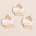 Close-up of alloy cat and strawberry cake pendants with glossy enamel finish for DIY crafts - Pink
