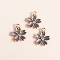 Macro detail of alloy sakura charms with blue enamel finish and sparkling rhinestones - Black