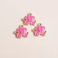 Detailed view of three rose pink enamel pumpkin carriage pendants with gold alloy finish - Rose Red