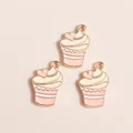 Detailed macro view of three pink cupcake enamel pendants with golden metal heart decor - Pink