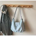 Detail of light blue shoulder bag with button flap closure and side zipper design - With Pendant / Blue
